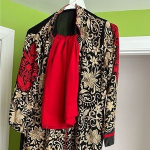 Indian salwar kurta. The salwar is red and skirts has embroidery work.